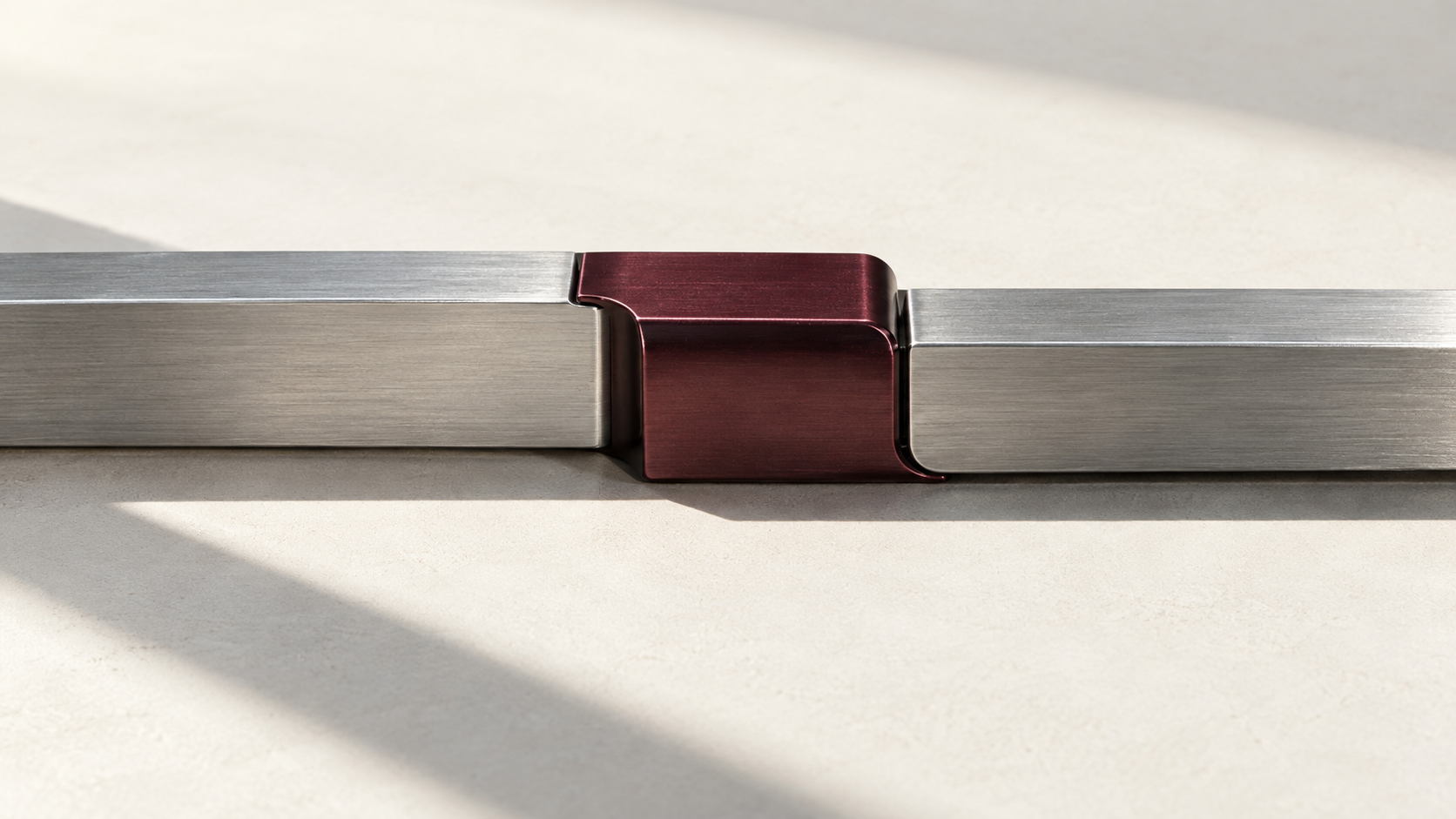 Parallel metal rails connected by a single oxblood link